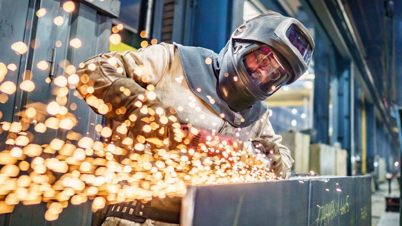 Metallhandwerker mit Trennschleifer, Funkenflug